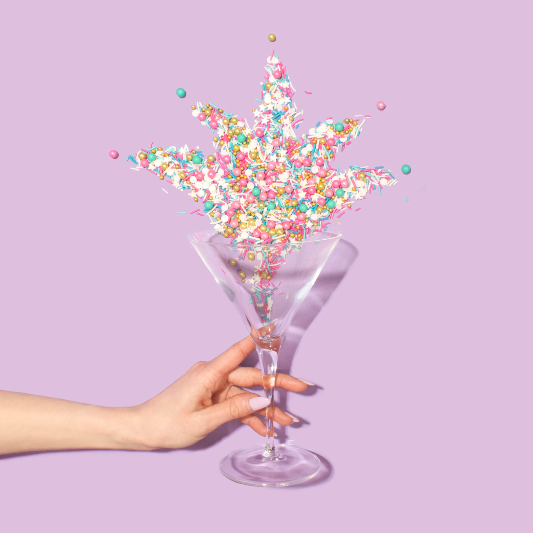 Three small milk jugs with a blue and pink colored straw with a donut inside the straw